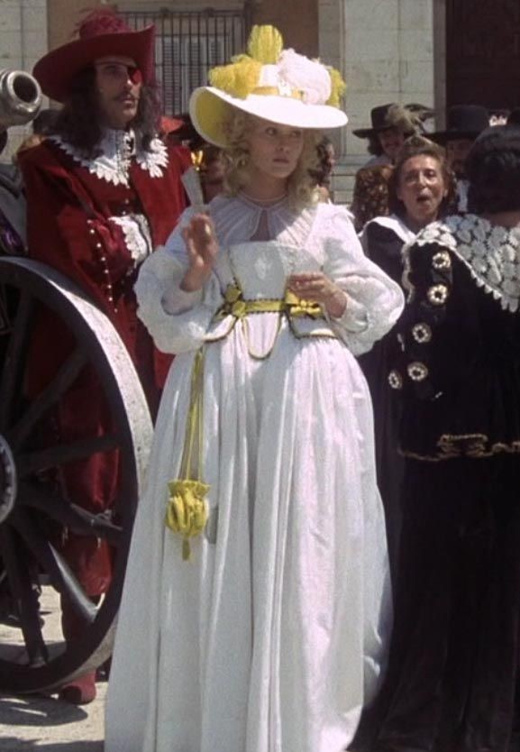 Milady tout en blanc, entourée de Rochefort (en rouge) et d'hommes en noir. La scène crée un très beau contraste de couleurs.